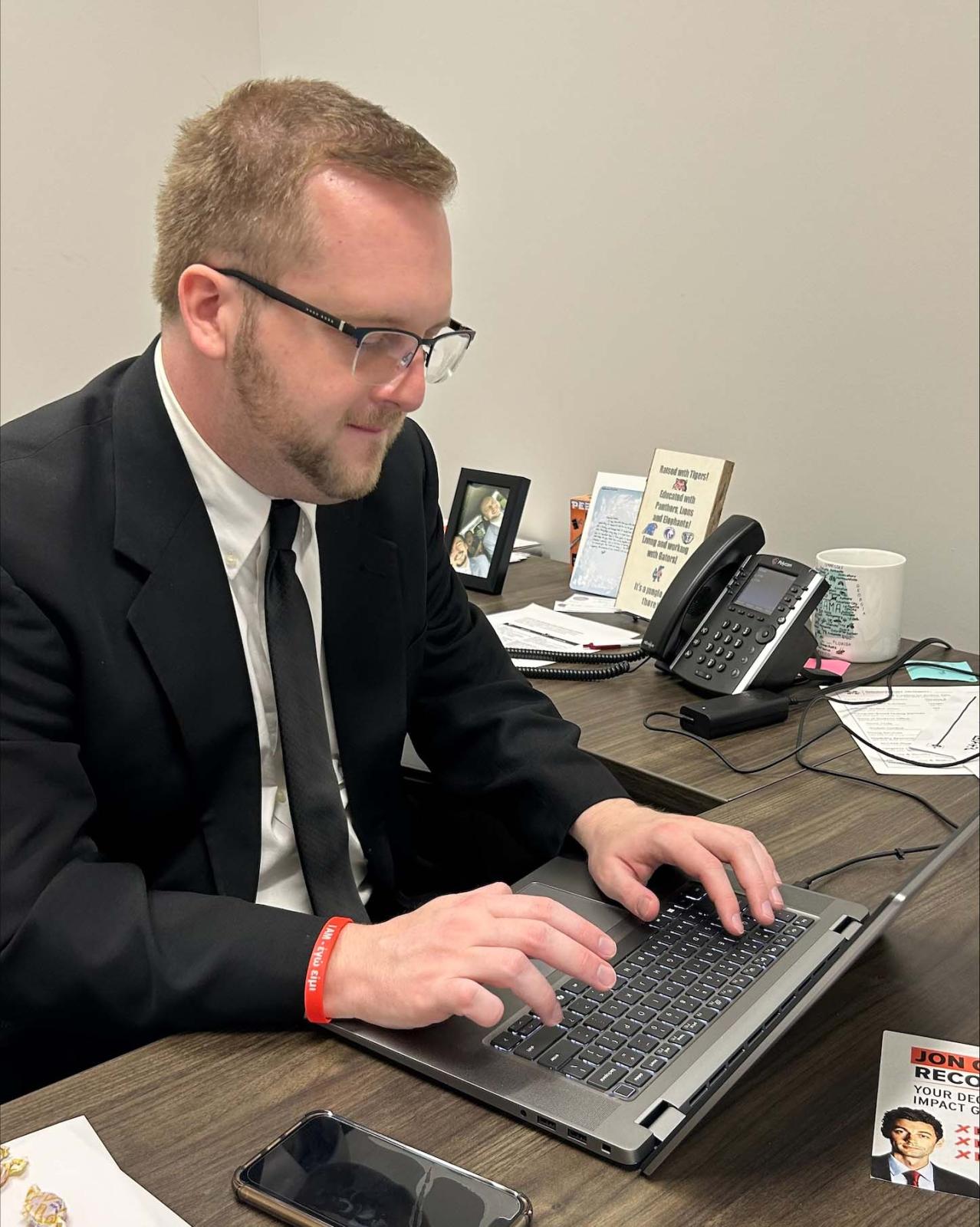 Gil Carter working on computer in his office.